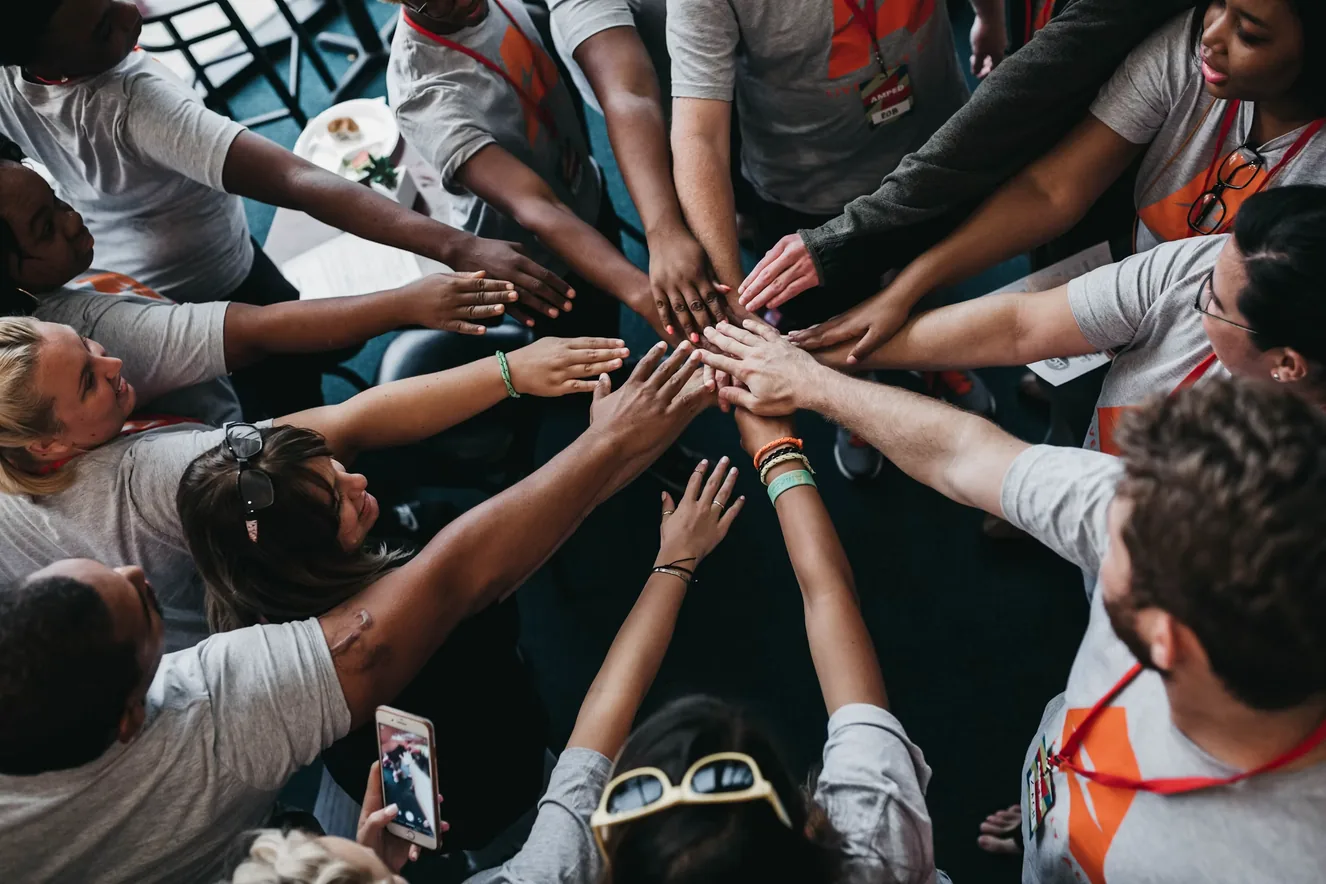 Co-op members stacking their hands together in a circle